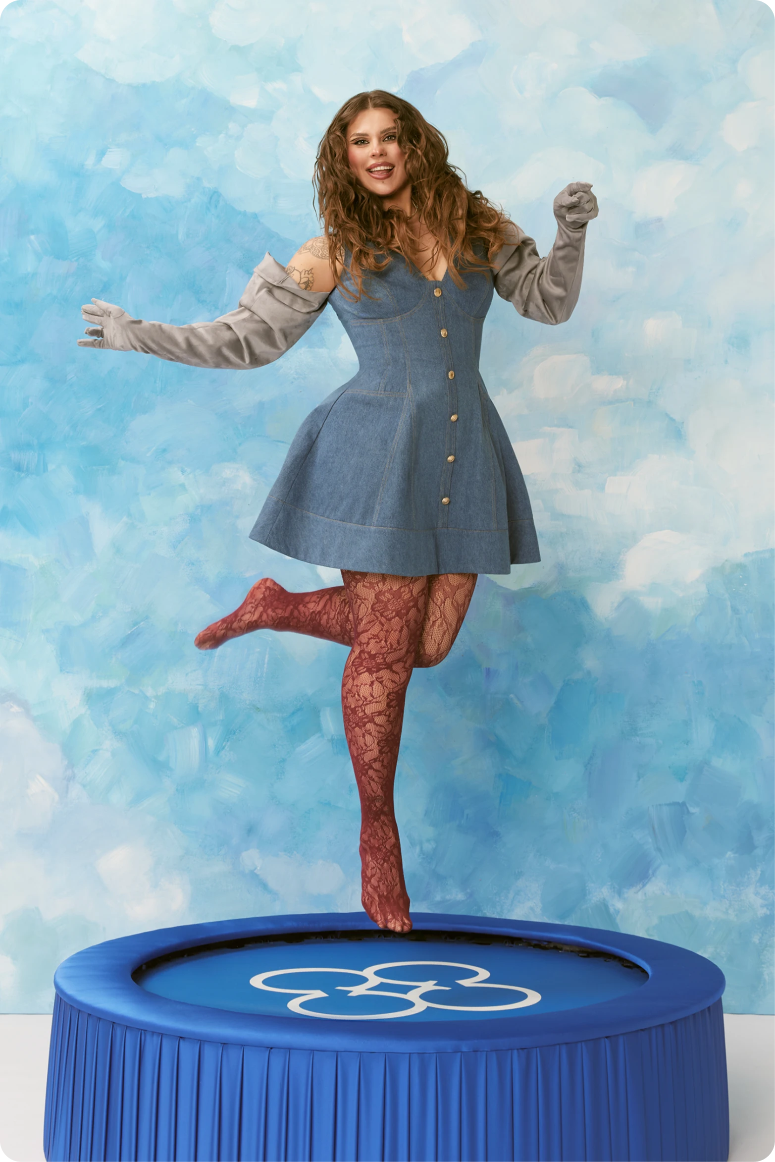 CHER'17 Show-Off campaign portrait of a woman in a blue dress jumping on a trampoline