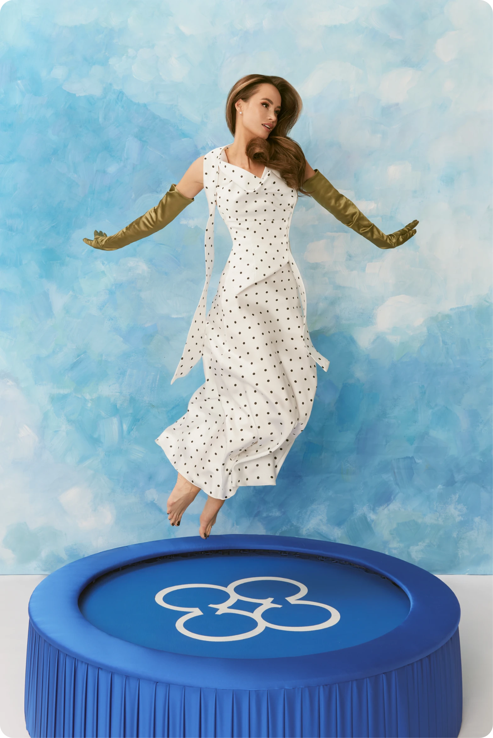 CHER'17 Show-Off campaign portrait of a woman in a polka-dot dress jumping on a trampoline